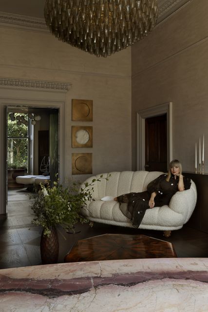 Róisín Lafferty on her white bouclé Bryan O’Sullivan croissant sofa. Photo: Barbara Corsico